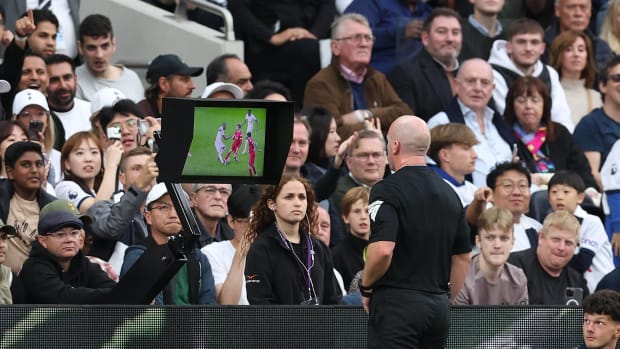 Referee Simon Hooper pictured looking at a pitch-side monitor moments before sending off Curtis Jones during Liverpool's 2-1 defeat at Tottenham in September 2023
